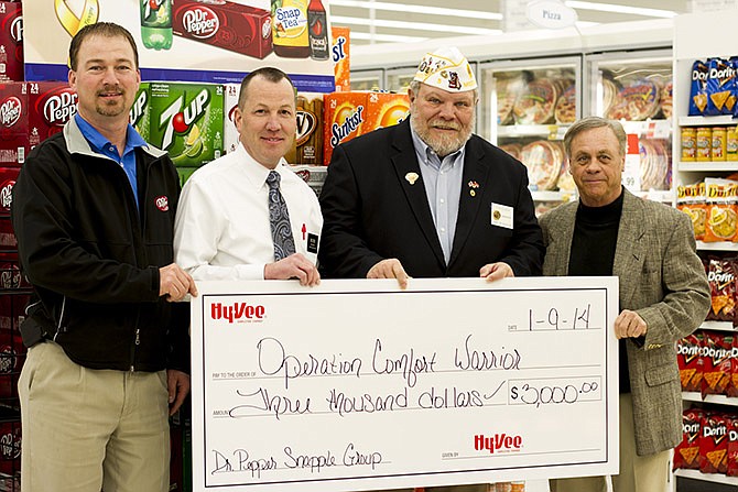 Rob McCurren and Chris Hilke from the Dr. Pepper Snapple Bottling Group along with Rod Dolph, Jefferson City
Hy-Vee store manager, recently presented a check for $3,000 to Missouri American Legion Commander Tom Goodin. The total was collected during a six-week, per-case donation program, which will continue annually.