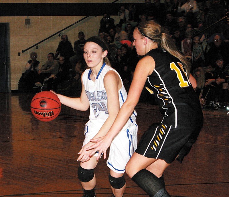 Jamestown's Robyn Eschenbrenner (24) drives around Bunceton's Rachel Emde during the Lady Eagles' Homecoming game Friday night. Bunceton won 62-48.