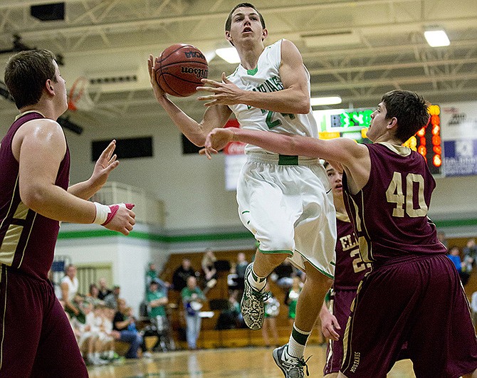 Blair Oaks senior Seth Eskens goes airborne as he looks to dish off a no-look pass Tuesday night during the Falcons' matchup against Eldon in Wardsville.