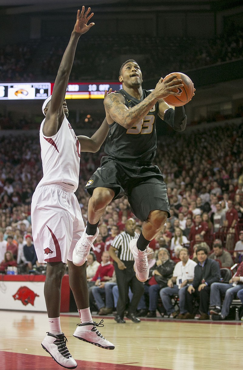 Missouri's Earnest Ross goes to the basket as Bobby Portis of Arkansas defends during the Tigers' 75-71 win against the Razorbacks last month in Fayetteville, Ark.