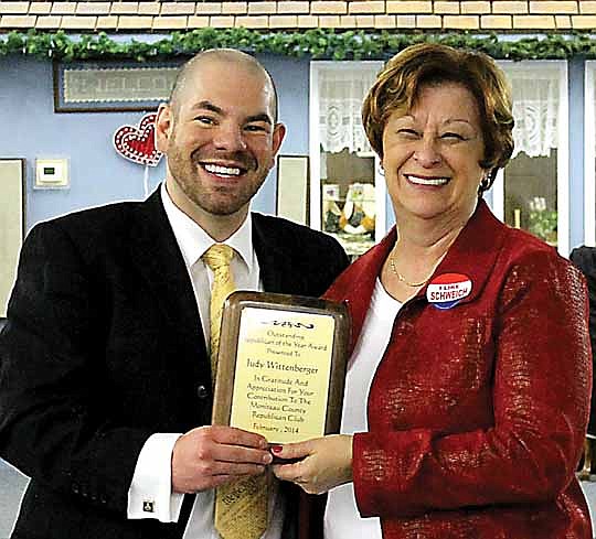 Bryan Wolford presents Judy Wittenberger with the plaque for Republican of the Year at the Annual Lincoln Day Dinner.
