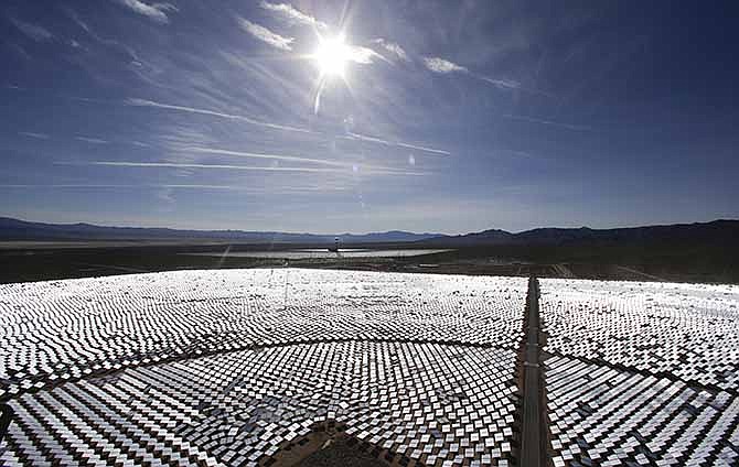 Some of the 300,000 computer-controlled mirrors, each about 7 feet high and 10 feet wide, reflect sunlight to boilers that sit on 459-foot towers. The sun's power is used to heat water in the boilers' tubes and make steam, which in turn drives turbines to create electricity Tuesday, Feb. 11, 2014 in Primm, Nev. The Ivanpah Solar Electric Generating System, sprawling across roughly 5 square miles of federal land near the California-Nevada border