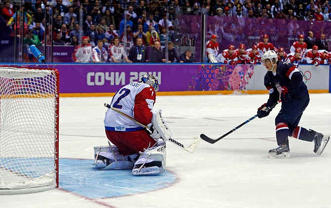 USA forward T.J. Oshie scores the winning goal against Russia goaltender Sergei Bobrovski in a shootout during overtime of a men's ice hockey game at the 2014 Winter Olympics, Saturday, Feb. 15, 2014, in Sochi, Russia.