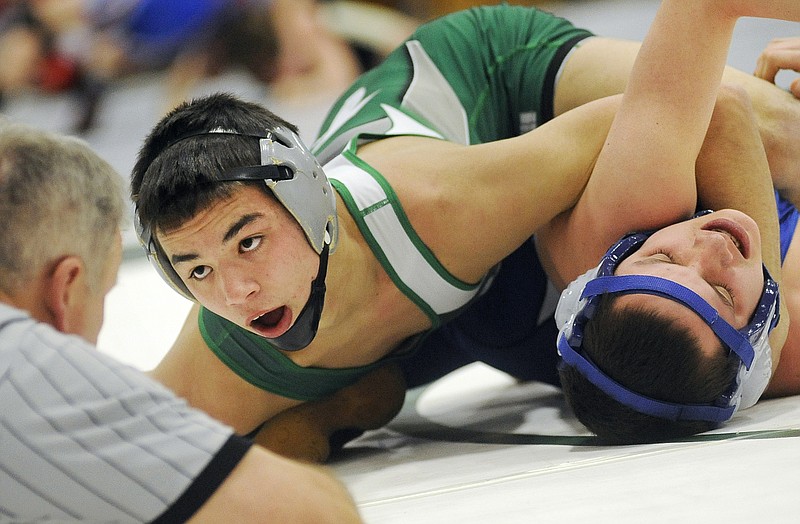 Frankie Falotico of Blair Oaks works Gabe Cozart of Hollister onto his back during their 126-pound match Friday night in Wardsville.