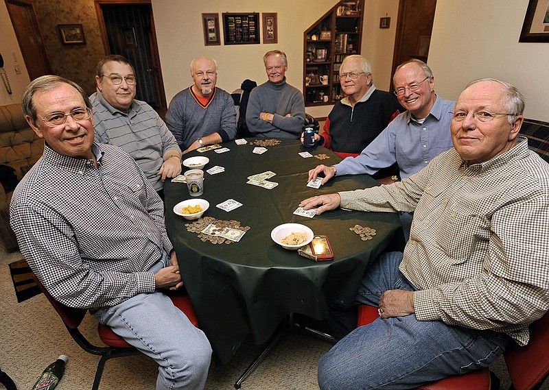 From left, poker buddies Dan Muessig, Bob Beck, Larry Ronimous, Eddie Mueller, Steve Beck, John Schwartze, and Norb Schwartze take a break from the poker action for a group photo. Inset below, the group watches as Bob Beck, bottom right, shows his hand to claim his second pot of the evening.
