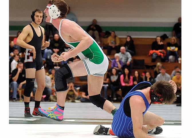 Logan Mudd of Blair Oaks celebrates after beating Auston Gerth of Holden (right) in the Class 1 District 2 145-pound title match Saturday in Wardsville, Mo.