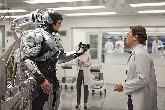 This image released by Columbia Pictures shows Joel Kinnaman, left, and Gary Oldman in a scene from "RoboCop."
