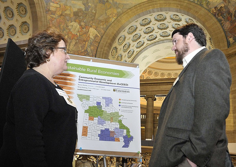 Sharon Gulick and John E. Meador discuss details Tuesday of regions of Missouri and how the Community Economic and Entrepreneurial Development (ExCEED) program is helping affect those communities. Meador is a graduate student working with Gulick, who is director of the program that falls under the purview of the University of Missouri Extension. Its purpose is to work with rural commmunities across the state to foster locally grown economic and business development.