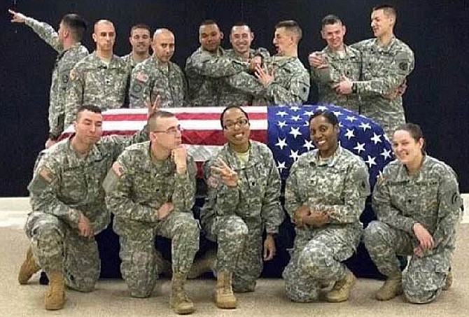 This photo posted to the Instagram account belonging to Spc. Terry Harrison shows a dozen soldiers clowning around a casket draped in a flag at a National Guard training facility in Arkansas.