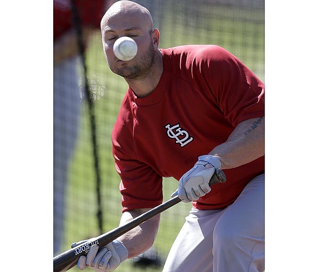 Matt Holliday of the Cardinals fouls off a ball while working on his bunting Tuesday in Jupiter, Fla.