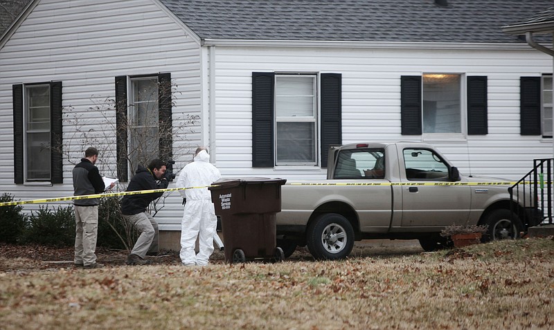 Police and FBI agents investigate the scene where Craig Michael Wood was arrested in Springfield, Mo., on Wednesday, Feb. 19, 2014. Wood is charged with first-degree murder in the abduction and death of a 10-year-old girl, police said.