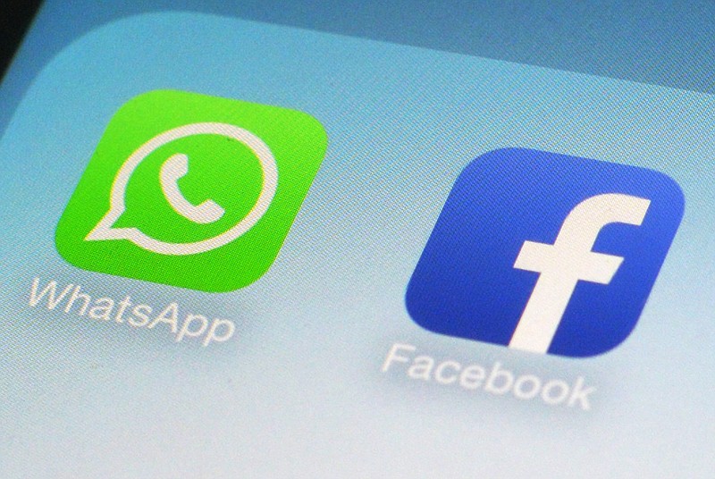 This Wednesday, Feb. 19, 2014 photo shows the WhatsApp and Facebook app icons on an iPhone in New York. On Wednesday the world's biggest social networking company, Facebook, announced it is buying mobile messaging service WhatsApp for up to $19 billion in cash and stock.