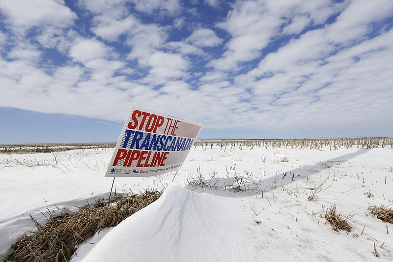 In this March 11, 2013 photo, a sign reading "Stop the Transcanada Pipeline" stands in a field near Bradshaw, Neb., along the Keystone XL pipeline route through the state. 