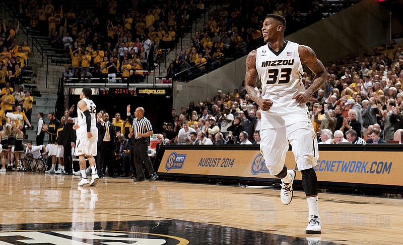 Missouri's Earnest Ross, right, smiles after making a three-point shot late in the second half of an NCAA college basketball game, Wednesday, Feb. 19, 2014, in Columbia, Mo. Missouri won the game 67-64.