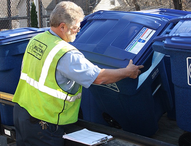 In this Dec. 2, 2012, file photo, a Fulton city worker unloads a recycling cart for distribution to a residence. The Missouri Legislature is considering a bill this year that would put limitations on how law enforcement officers can collect and use evidence from people's curbside disposal carts.