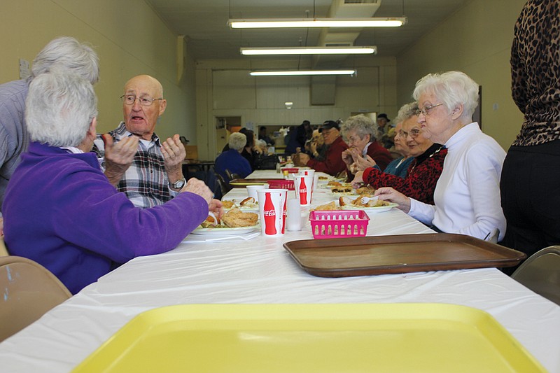 Attendees of Auxvasse Loafer's Week visit and enjoy fried chicken prepared by the Fulton Masonic Lodge in February 2013. Traditionally held the week of President's Day, Loafer's Week will take place this year during the last week of March.