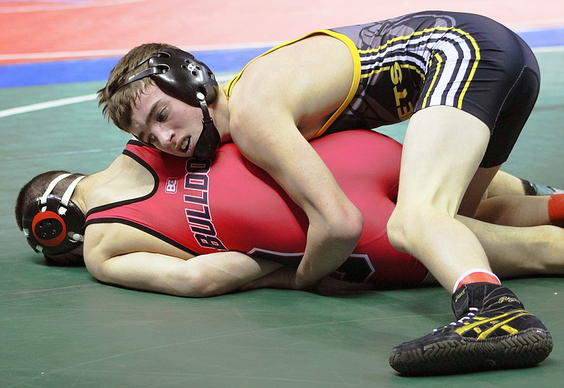 Fulton sophomore Josh McClure bears down on Odessa junior Brett Shull in his 14-0 victory at 113 pounds in Thursday's first round of the Class 2 state championships at Mizzou Arena in Columbia.
