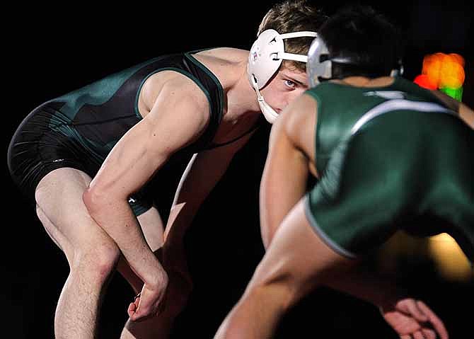 Derrick Swaney of Whitfield stares at Blair Oaks' Frankie Falotico as introductions are made prior to a title match Saturday at Missouri's state wrestling championships. Falotico lost that contest but his team became the Class 1 champs.