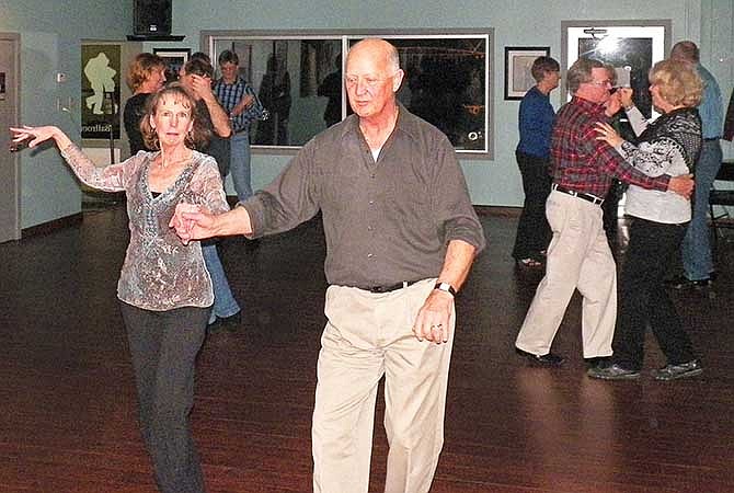 Steppin' Out Dance Studio instructors Becky Fredrickson and Don Walker (forefront) dance during Friday
night's Valentine Dance. The studio, 2304 E. McCarty St., hosts a dance the third Friday of each month.
