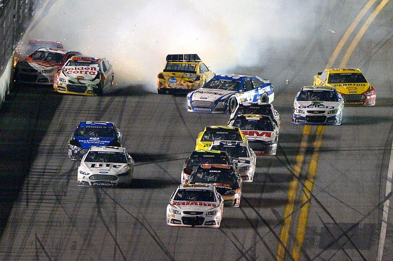 With a wreck erupting behind him, Dale Earnhardt Jr. races to the finish line while winning Sunday's Daytona 500.