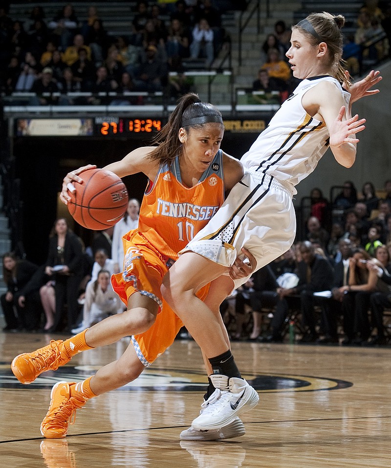 Tennessee's Meighan Simmons pushes through Missouri's Jordan Frericks as she drives toward the basket during Sunday's game in Columbia.