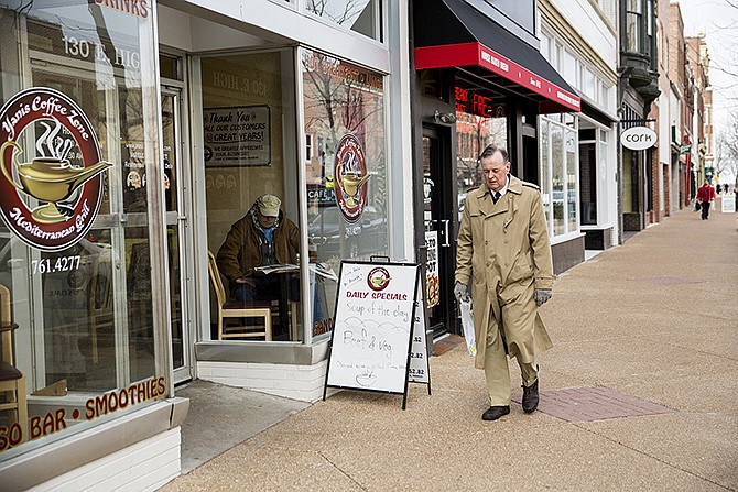 Customers walk along downtown sidewalks Monday afternoon. A proposal to maintain the aesthetic downtown will call for a special assessment of $8 per square foot of street frontage for downtown businesses. The money would go toward maintaining sidewalks and flower baskets as well as helping pay for holiday lights.