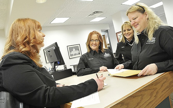 Susan Cook completes her paperwork to run for the office of Cole County clerk. She was one of the last in the initial rush to file Wednesday morning, so she had plenty of assistance from the clerk's office staff. 