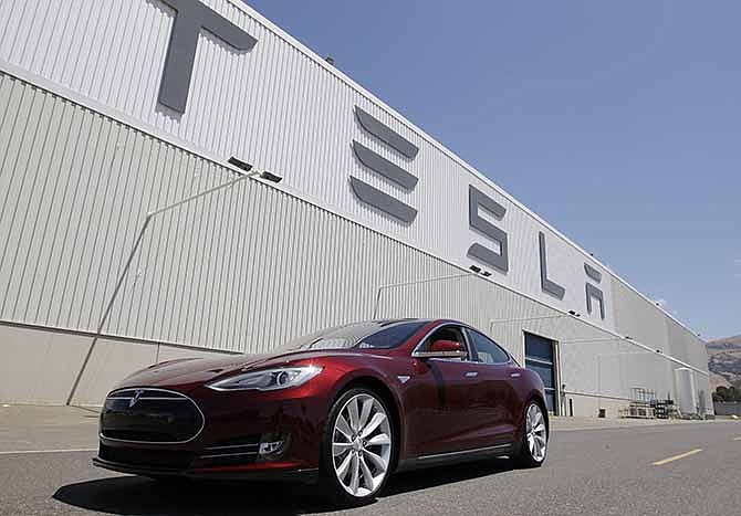 This June 22, 2012 file photo shows a Tesla Model S outside the Tesla factory in Fremont, Calif. 