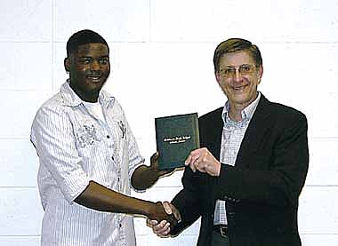 Del'Von Hite, left, is presented with his California High School Diploma by school board President Steven Burger Wednesday, Feb. 19, at the school board meeting. He is the first to be awarded the diploma under the Missouri Options Program after the GED has been toughened.