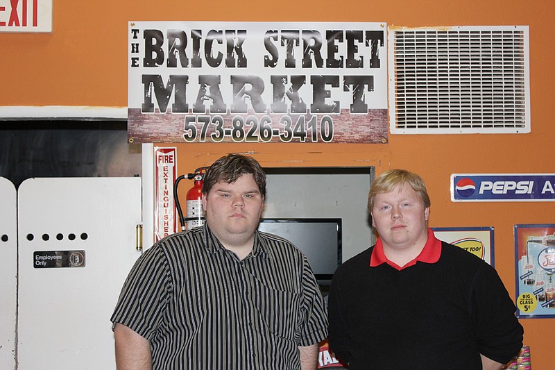 Jeremy and Michael Harrison stand in their newly-opened store, The Brick Street Market, 505 Nichols St.