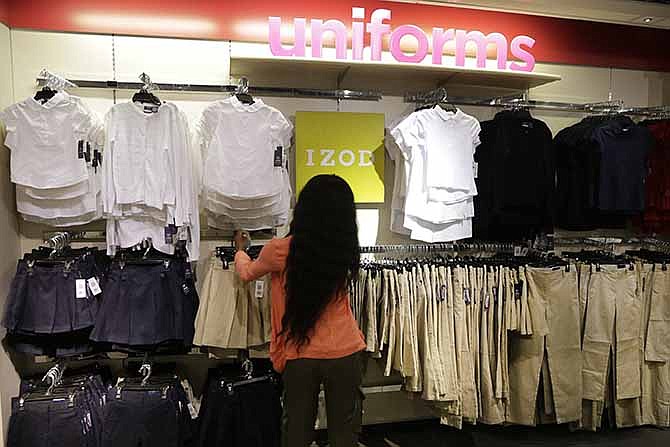 In this July 31, 2013, file photo, school uniforms by Izod are displayed at J.C. Penney in New York.