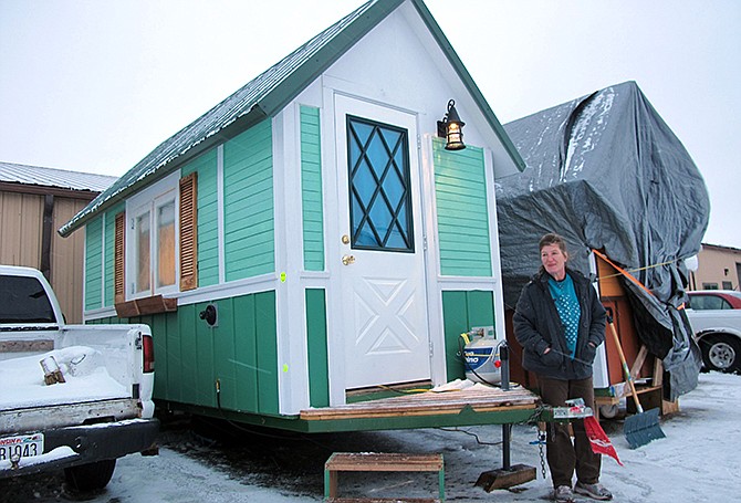 Betty Ybarra, 48, stands outside a tiny house she and her boyfriend live in, in Madison, Wis. It is the first house built by OM Build, which wants to build nine houses in Madison for the homeless. 