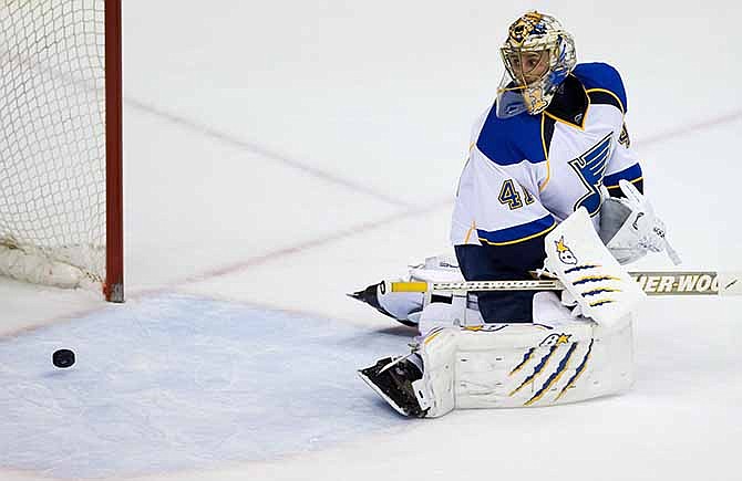 St. Louis Blues' goalie Jaroslav Halak, of Slovakia, allows the only goal of the game to Vancouver Canucks' Jannik Hansen, of Denmark, during third period NHL hockey action in Vancouver, British Columbia, on Wednesday, Feb. 26, 2014.