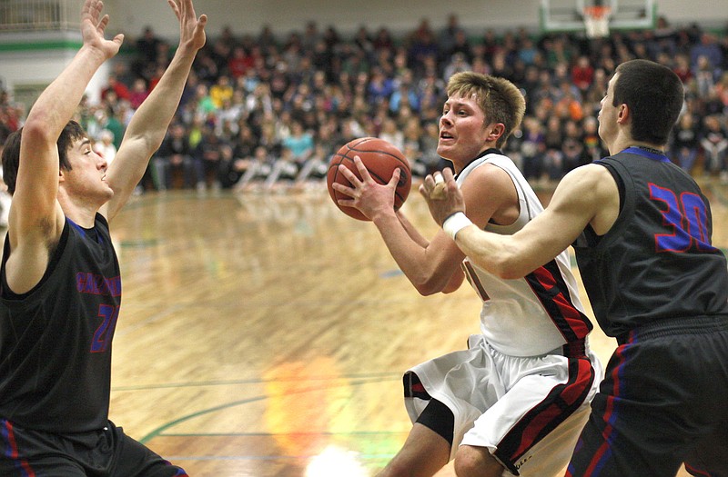 California teammates Jerry Lutz (left) and Drew Norton close in on Travis Kempker of Eugene during Class 3 District 8 Tournament semifinal action Thursday night in Wardsville.