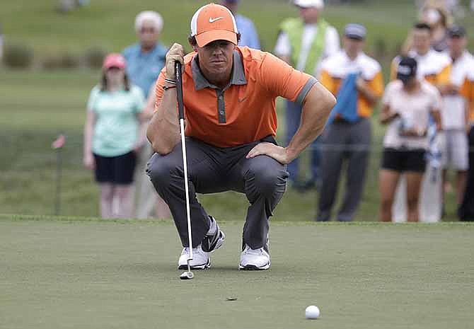 Rory McIlroy of Northern Ireland lines up a putt on the fourth hole during the first round of the Honda Classic golf tournament, Thursday, Feb. 27, 2014, in Palm Beach Gardens, Fla. 