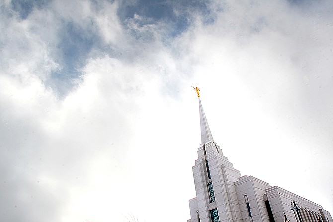 The Mormon Temple in Rexburg, Idaho is shown against a sky of clouds. A newly-posted article, part of a series of recent online articles posted on the website of The Church of Jesus Christ of Latter-day Saints, affirms the Mormon faith's belief that humans can become like God in eternity, but explains that the "cartoonish image of people receiving their own planets" is not how the religion envisions it.