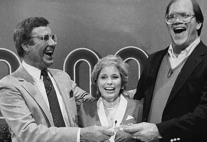 This Jan. 16, 1986. file photo shows host Jim Lange, left, congratulating Connie and Steve Rutenbar of Mission Viejo, Calif., after they won $1 million on the TV show " The $1,000,000 Chance of a Lifetime". Lange, the first host of the popular game show "The Dating Game," has died at his home in Mill Valley, Calif. He was 81. He died Tuesday morning after suffering a heart attack, his wife Nancy told The Associated Press Wednesday, Feb. 26, 2014. 