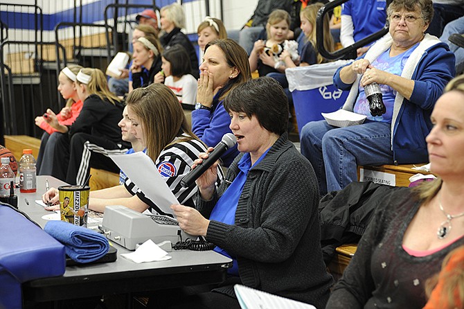 Hosting a Missouri State High School Activities Association basketball tournament requires a cadre of volunteers and workers. Russellville Schools have relied on Patty Smith, center, to work the scoreboard and books since the 1980s.