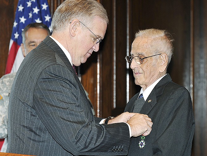 Gov. Jay Nixon presented WWII Veteran John Sullivan with the French Legion of Honor medal during a brief ceremony in the Governor's office Friday morning. Sullivan enlisted in the Army AirCorps' Aviation Cadet Program in May 1942. He served 35 missions on board a B-24 Liberator heavy bomber.