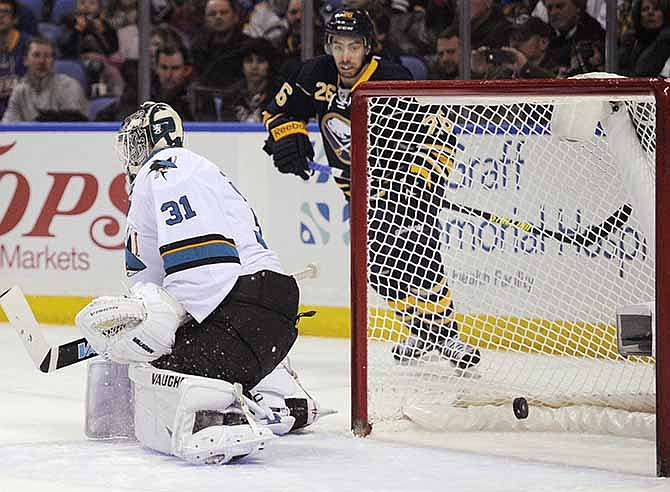 San Jose Sharks goaltender Antti Neimi (31), of Finland, is scored on by Buffalo Sabres' Cody Hodgson, not seen, as Sabres left winger Matt Moulson (26) watches during the first period of an NHL hockey game in Buffalo, N.Y., Friday, Feb. 28, 2014.