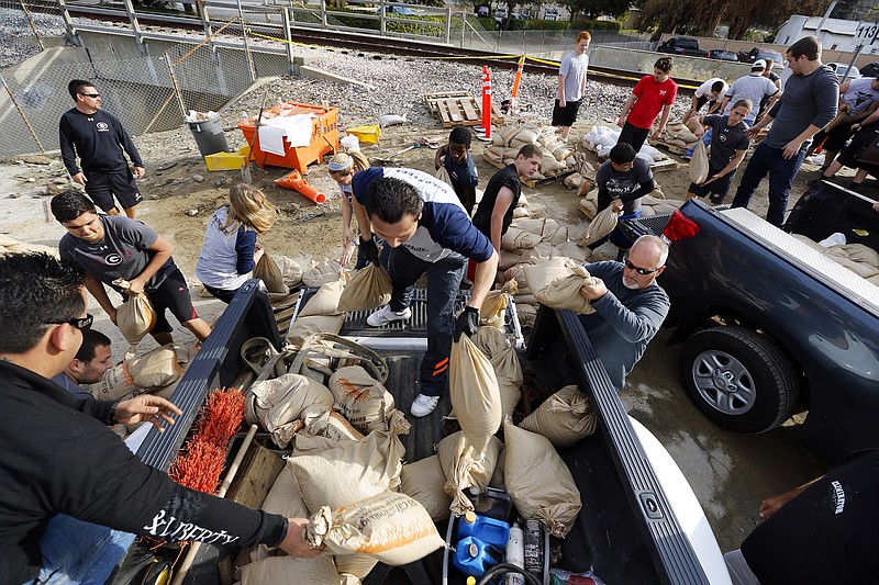 Volunteers fill sandbags in the City of Glendora, Calif. Residents with the help of their city, prepare for possible flooding. In advance of a powerful Pacific storm, mandatory evacuation orders have been issued for 1,000 homes in Glendora and Azusa, two of Los Angeles' eastern foothill suburbs, which are located beneath nearly 2,000 acres of steep mountain slopes left bare by a January fire.