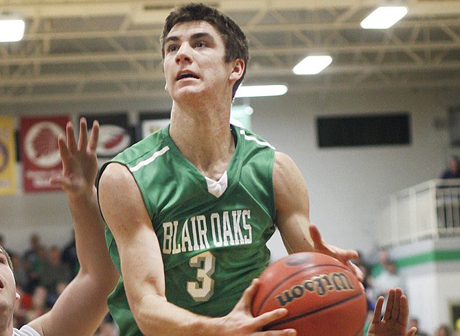 Logan Bax of Blair Oaks soars toward the basket as Versailles teammates Michael Allen (40) and junior Trey Woods (1) look on during Thursday night's Class 3 District 8 semifinal game in Wardsville.