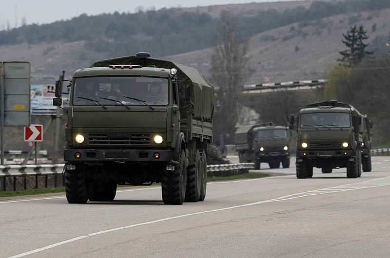 A Russian convoy moves from Sevastopol to Sinferopol in the Crimea, Ukraine, ON Sunday. A convoy of hundreds of Russian troops headed toward the regional capital of Ukraine's Crimea region on Sunday, a day after Russia's forces took over the strategic Black Sea peninsula without firing a shot. 