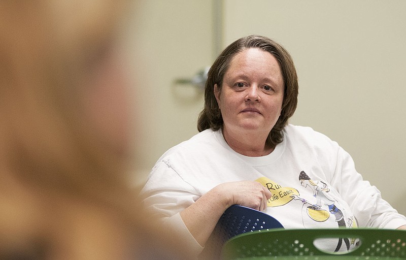 Cindy Baker of Fulton listens as an attendee of the Callaway County Public Library event, "De-clutter, Recycle & Re-purpose" shares tips on letting go of household items Tuesday night. Baker, founder of a local all-purpose errand and cleaning company called ErrandRunners, lead the discussion Tuesday and offered solutions on how to de-clutter spaces.