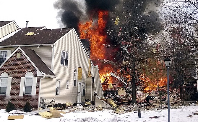 Flames and smoke shoot up after an explosion at a townhouse complex Tuesday in Ewing, N.J. A gas line damaged by a contractor exploded "like a bomb" while utility crews worked to repair it.