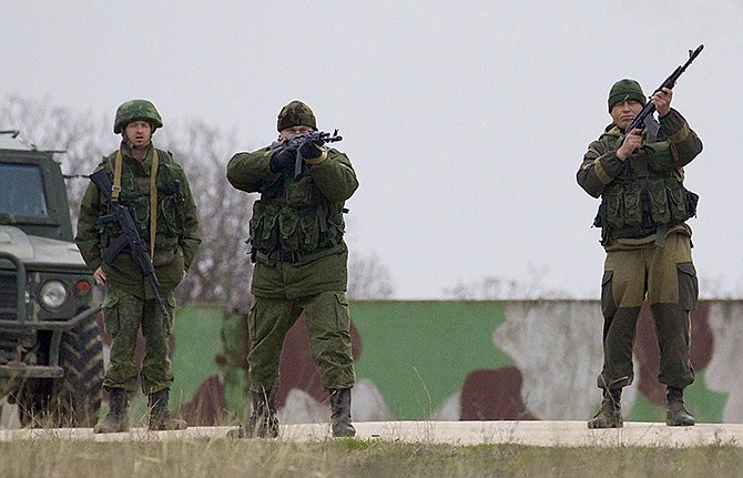 Russian troops, who had taken control over Belbek airbase, fired warning shots in the air Tuesday as around 300 Ukrainian officers marched towards them to demand their jobs back. 