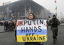 A woman holds a poster against war at Kiev's Independence Square, in Ukraine, on Thursday.