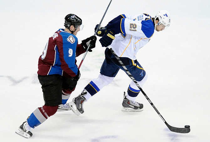 Colorado Avalanche center Matt Duchene, left, tries to catch St. Louis Blues center Patrik Berglund, right, in the first period of an NHL hockey game on Saturday, March 8, 2014, in Denver. 