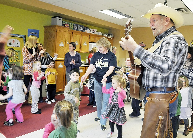"Cowboy" Tom Whittle entertains students and staff in the classroom at the Special Learning Center.