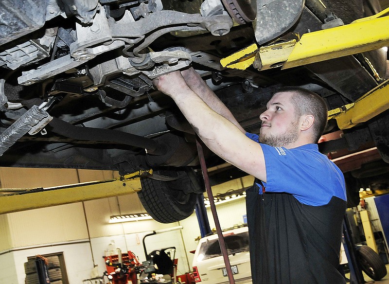 Dusty Simmons works on a vehicle at Capitol City Chrysler. Simmons attended Nichols Career Center and Linn State Technical College for auto mechanics. He worked part time at the dealership and is now a full-time certified mechanic.
